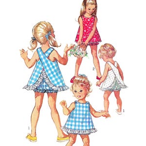 May include: Illustration of children's dress patterns. The image shows four children wearing different dresses. The dresses are in various styles and colors, including blue gingham and floral prints. The text reads "Paper Ladies Patterns" and "S-8165 • Chest 22"/56cm."
