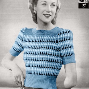 May include: A short-sleeved knit top featuring a blue, light blue, and black geometric pattern with a ribbed neckline, cuffs, and hem. The image includes text reading Paper Ladies Patterns No 915 3d and Hand Knitwear in Lavenda.