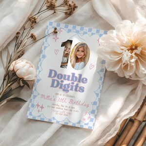May include: A birthday invitation with a light blue and white checkered border. The invitation features the text "Double Digits" in a light blue and pink font, with a photo of a young girl. The invitation also includes the text "Millie's 10th Birthday".