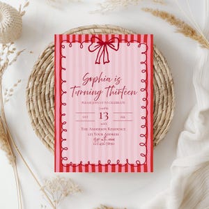 May include: A pink and red birthday invitation with the text "Sophia is Turning Thirteen." The invitation has a striped background and a decorative border. The date and time of the event are also included.