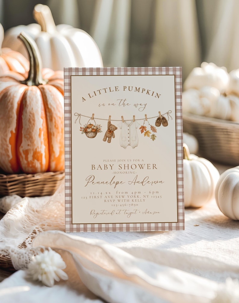 May include: A rectangular baby shower invitation card with a brown and white gingham border. The text reads A LITTLE PUMPKIN is on the way, BABY SHOWER, honoring Pennelope Anderson, 11-14-xx, 4pm-6pm, 123 FIRST AVE NEW YORK, NY 12345, RSVP WITH KELLY 123-456-7890, Registered at Target + Amazon.