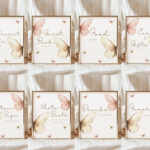 May include: Set of eight framed signs with butterfly illustrations. Each sign has a different text: Dessert Table, Guest Book, Food, Cards & Gifts, Custom Sign, Photo Booth, Drinks, and Favors. The signs have a beige background with gold frames.