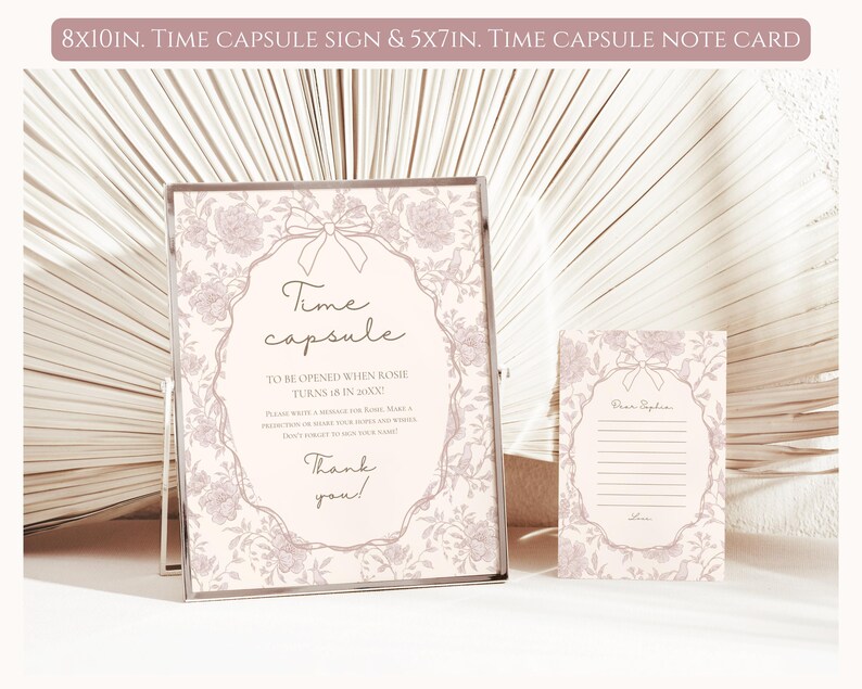 May include: A pink and white time capsule sign with a floral design and the text "Time capsule to be opened when Rosie turns 18 in 20XX". The sign is 8x10 inches. A smaller pink and white note card with a floral design and the text "Dear Rosie" is 5x7 inches.