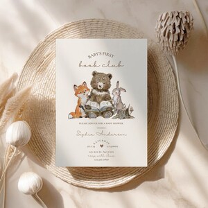 May include: A baby shower invitation with the text "BABY'S FIRST book club". The invitation features a watercolor illustration of a fox, bear, and rabbit reading a book. The invitation includes the date, time, and location.