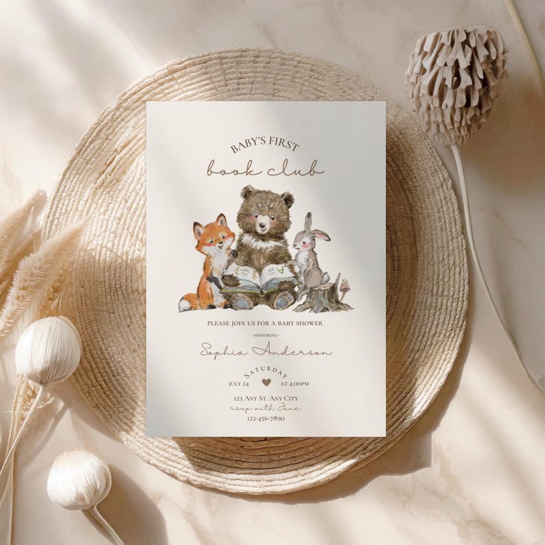 May include: A baby shower invitation with the text "BABY'S FIRST book club". The invitation features a watercolor illustration of a fox, bear, and rabbit reading a book. The invitation includes the date, time, and location.