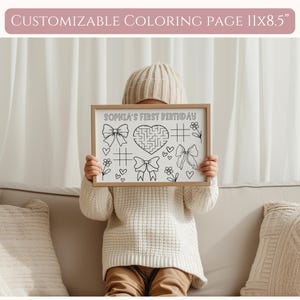 May include: A black and white printable coloring page with a maze, hearts, bows, and flowers. The page is titled "Sophia's First Birthday".