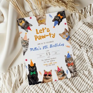 May include: A white invitation card with the text "Let's Paw-ty" and "Millie's 8th Birthday". The card features illustrations of cats wearing party hats and bow ties. The date is August 13th.