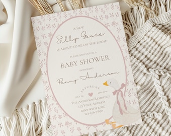 May include: A pink and white baby shower invitation with a cartoon goose illustration. The invitation reads "A New Silly Goose is About to Be on the Loose." It also includes the date, time, and location of the shower.