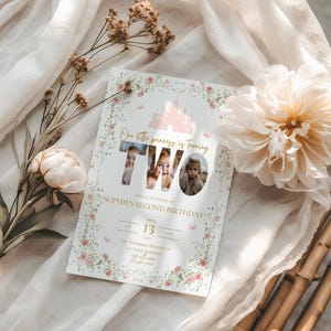 May include: A custom invitation for a second birthday celebration. The invitation features a pink castle illustration, floral accents, and the text "Our little princess is turning TWO". The invitation includes the date, time, and location of the party.