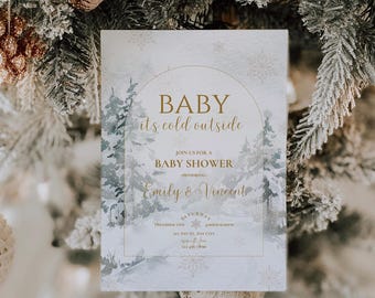 May include: A baby shower invitation with a winter theme. The invitation features a watercolor illustration of a snowy forest with pine trees and snowflakes. The text reads "Baby it's cold outside" and "Join us for a Baby Shower honoring Emily & Vincent".