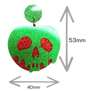 May include: Green and red glitter apple-shaped earring with a skull design. The earring measures 40mm wide and 53mm tall.