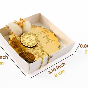 May include: A gold-colored, decorative plaque with Arabic calligraphy and the names "Khalid & Sara" and the date "06.12.2024" engraved on it. The plaque is in a white box with a gold ribbon. The box measures 3.14 inches by 3.14 inches by 0.80 inches.