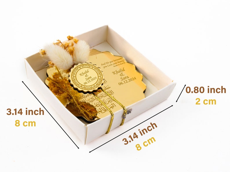 May include: A gold-colored, decorative plaque with Arabic calligraphy and the names "Khalid & Sara" and the date "06.12.2024" engraved on it. The plaque is in a white box with a gold ribbon. The box measures 3.14 inches by 3.14 inches by 0.80 inches.