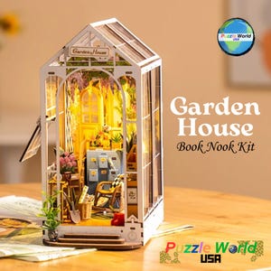 May include: A wooden model kit of a garden house with a glass roof and a small door. The kit includes a variety of miniature furniture and accessories, such as a rocking chair, a table, and a bookshelf. The kit is labeled "Garden House Book Nook Kit" and is made by Puzzle World USA.