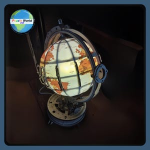 May include: A wooden globe with a lit-up world map, mounted on a base with gears and a compass. The globe is made of wood and has a light brown finish. The base is made of metal and has a dark brown finish. The globe is illuminated from the inside, creating a warm glow. The globe is a decorative piece that can be used as a nightlight or a conversation starter.