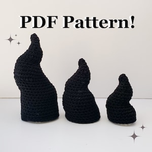 May include: Three black crocheted horns of varying sizes. The horns are shaped like a pointed, curved shape. The image includes the text "PDF Pattern!" at the top.
