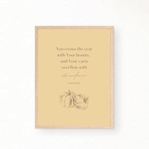 May include: A yellow printable art print with a quote about abundance from Psalm 65:11. The quote reads "You crown the year with Your bounty, and Your carts overflow with abundance." The print features a hand-drawn illustration of two pumpkins.