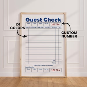 May include: A framed print of a restaurant guest check with blue lines and text on a white background. The design includes fields for date, table, guest, and server, with the red text 102724. Black arrows point to the check with text 24 COLORS and CUSTOM NUMBER.