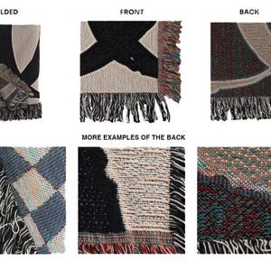 May include: A woven throw blanket with a black and white design on the front and a multicolored design on the back. The blanket is folded in half and shows the front and back sides. The blanket has fringe on all sides.