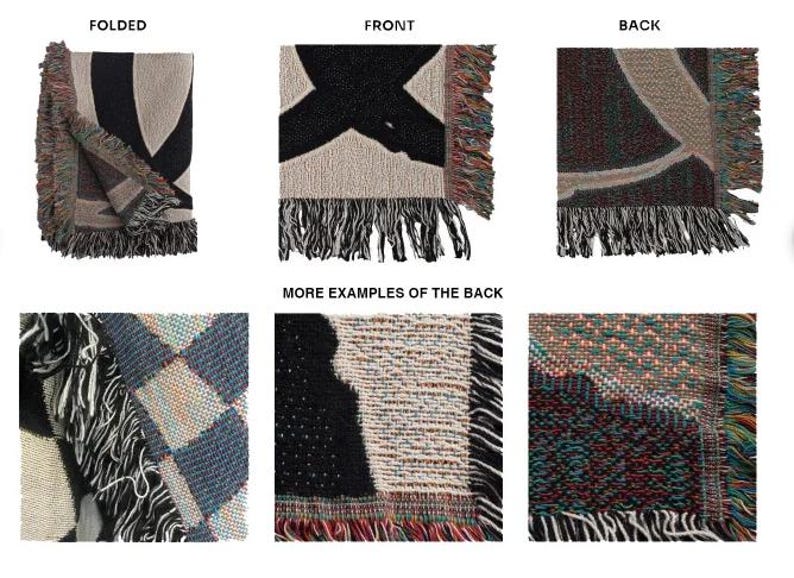 May include: A woven throw blanket with a black and white design on the front and a multicolored design on the back. The blanket is folded in half and shows the front and back sides. The blanket has fringe on all sides.