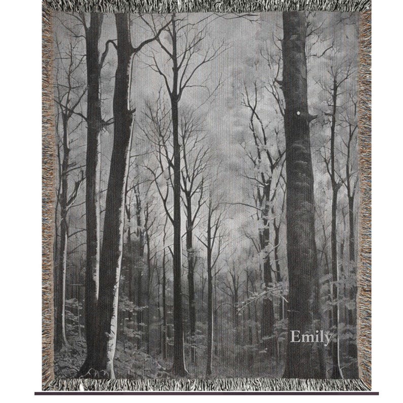 May include: Black and white woven tapestry featuring a forest scene with tall trees and a misty background. The tapestry has a fringe border and the word "Emily" is woven into the bottom right corner.