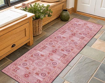 Könnte beinhalten: Ein rechteckiger, rosafarbener Läuferteppich mit einem aufwendigen, geometrischen Muster. Der Teppich zeigt ein sich wiederholendes Design aus Kreisen, Rechtecken und anderen Formen in Rosa-, Rot- und Weißtönen mit einem schwarzen Rand. Der Teppich liegt auf einem gefliesten Boden.
