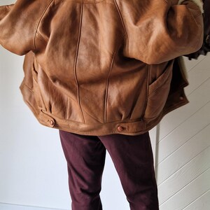 Back view of Shearling Original jacket showing natural camel cinnamon sheepskin leather texture.