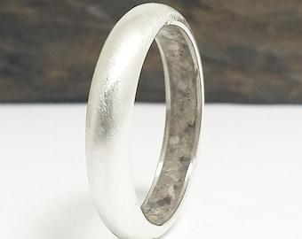 Silver ring with cremation ashes inside