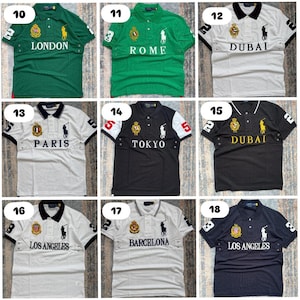 May include: Collection of polo shirts in various colors, each featuring city names like London, Rome, and Dubai. The shirts have short sleeves, collars, and embroidered logos. The shirts are available in green, white, black, and navy blue.