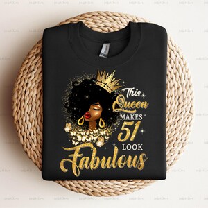 May include: Black t-shirt with a gold crown, a black woman with gold earrings, and the text "This Queen Makes 51 Look Fabulous".