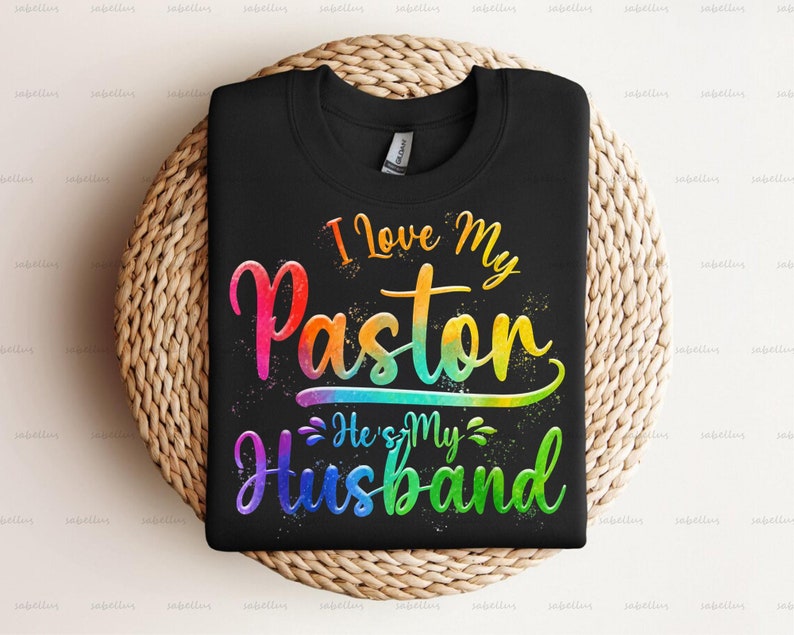 May include: Black t-shirt with a rainbow design that says "I Love My Paston He's My Husband".