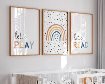 May include: Three framed prints with a white background and colourful designs. The left print says "Let's Play" in a colourful font. The middle print has a rainbow with polka dots. The right print says "Let's Read" in a colourful font.