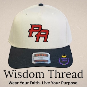 May include: A white and navy blue baseball cap with the embroidered letters "PR" in red. The cap has a curved brim and a button on top. The text "Wisdom Thread" and "Wear Your Faith. Live Your Purpose." are at the bottom.