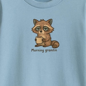 Funny Raccoon Shirt – Morning Gremlin Coffee Tee – Cute Tired Animal T-Shirt – Cozy Boutique Cartoon Gift for Pet Lovers or Coffee Addicts