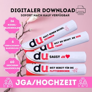 May include: Three white tubes with pink and black text and graphics. The text on the tubes reads "du" and includes phrases like "Hast deinen Deckel gefunden", "Bist die Braut, die sich traut", "Sagst Ja", and "Bist bereit für die Flitterwochen". The tubes are labeled with the quantities 36, 6, and 60. The text "JGA/HOCHZEIT" is at the bottom of the image.