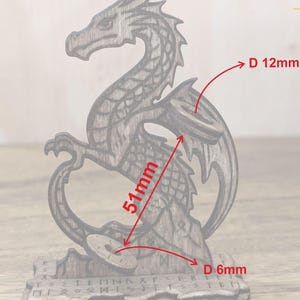 May include: Wooden dragon figurine, 51mm tall, with a circular design and engraved runes. The dragon has a detailed, carved appearance and is made of a light brown wood. The circular design is 12mm in diameter, and the base is 6mm in diameter.