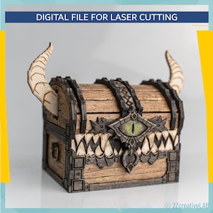 May include: A wooden chest with a dragon-themed design, featuring horns, a central eye, and a toothy lower edge. The chest is made for laser cutting and has the text "DIGITAL FILE FOR LASER CUTTING".
