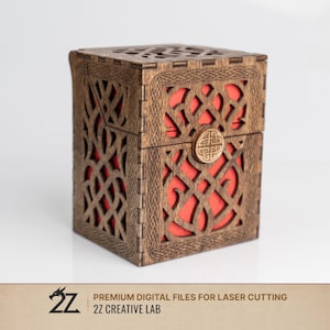 May include: A wooden box with intricate Celtic knotwork cutouts and a red interior. The box has a hinged lid and a circular clasp. The design is laser cut, showcasing detailed craftsmanship. The box is a decorative storage item.