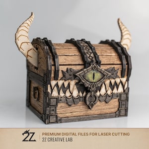 May include: A wooden treasure chest with a fantasy design. The chest features curved horns, a central eye, and a jagged, tooth-like border. The chest is made of wood with dark accents.