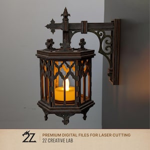 May include: A dark brown, gothic-style wall-mounted lantern with an ornate design. The lantern features a lit, yellow candle inside. The design includes decorative cutouts and a cross-shaped top. The text "PREMIUM DIGITAL FILES FOR LASER CUTTING" and "2Z CREATIVE LAB" is visible.