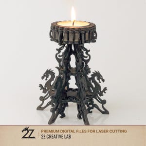 May include: A dark brown laser-cut candle holder with a lit candle. The holder features a dragon design and decorative cutouts. The base has two dragon silhouettes. The text "PREMIUM DIGITAL FILES FOR LASER CUTTING" and "2Z CREATIVE LAB" are visible.