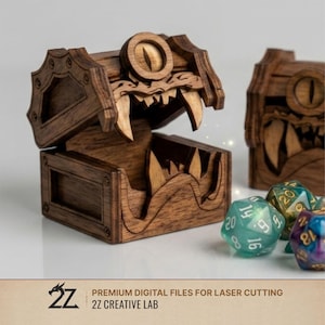 May include: A dark brown wooden mimic chest with a single central eye and sharp teeth, featuring an open lid. The text 2Z CREATIVE LAB PREMIUM DIGITAL FILES FOR LASER CUTTING is visible at the bottom. Several multi-sided dice are placed nearby.