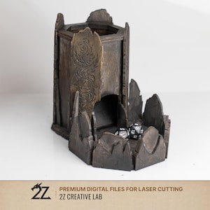 May include: A dark brown wooden dice tower with a hexagonal base and a tall vertical chute. The front panel features an engraved spiral design and a geometric symbol. Two black polyhedral dice rest in the tray. Text at the bottom reads 2Z PREMIUM DIGITAL FILES FOR LASER CUTTING 2Z CREATIVE LAB.