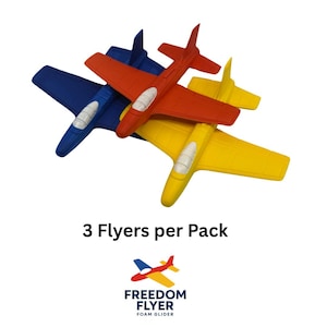 May include: Three foam glider aeroplanes in red, yellow, and blue. Each plane has a white cockpit. The image includes the text "3 Flyers per Pack" and the Freedom Flyer logo.