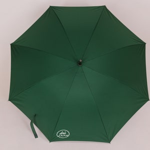 May include: A green umbrella with a white logo that says "dri-z-air" on it.