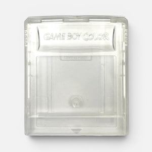 May include: A clear, transparent plastic Game Boy Color video game cartridge. The rectangular casing features the embossed text GAME BOY COLOR at the top, with a central circular screw hole and a small triangular arrow indicator at the bottom edge.