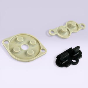 May include: A white ceramic mug with a black handle and the text "But First, Coffee" in a black, handwritten-style font. The mug is on a white surface.