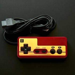 Famicom Shell NES Controller: Retro Gaming Pad with Black DMG Buttons