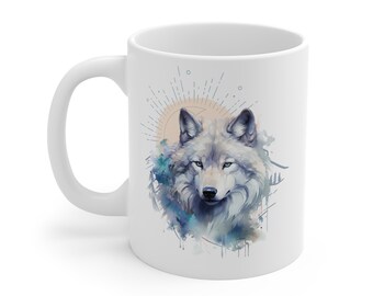 May include: White ceramic mug with a watercolor illustration of a wolf's head in front of a sun and mountain scene.
