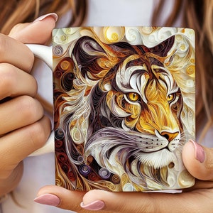 May include: A white ceramic mug with a colorful tiger face design. The tiger's face is made up of intricate swirls and patterns in shades of orange, yellow, brown, and purple.